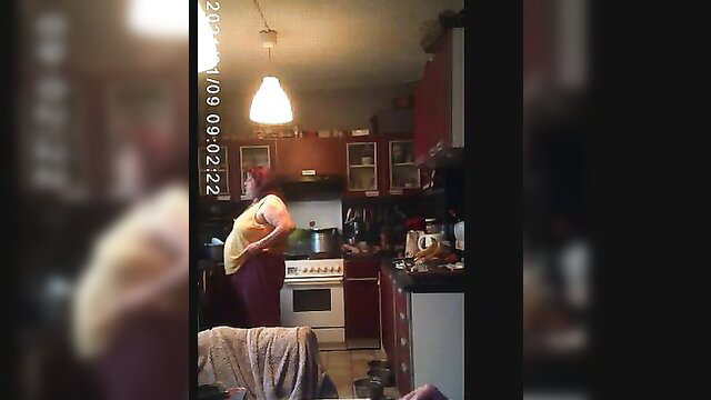 Cherie bent over kitchen counter in tight top, red hair