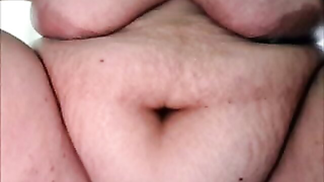 Closeup of mature woman's hairy pussy and fat belly spread wide