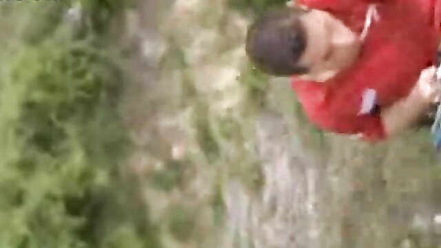 Hot guy in red shirt rock climbing outdoors adventure