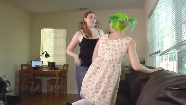 Redhead in tank top dances with green-haired girl in floral dress humping