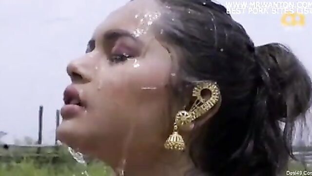 Indian beauty wet look in gold earrings, face profile closeup