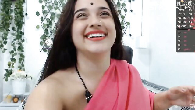 Indian cute girl smiling in pink saree showing deep cleavage