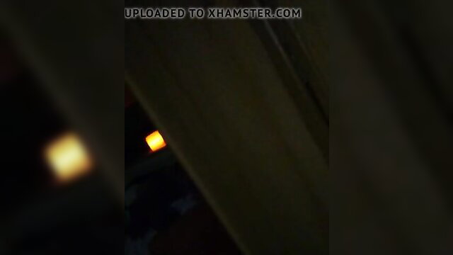 Blurry closeup of yellow light glow in dark amateur scene