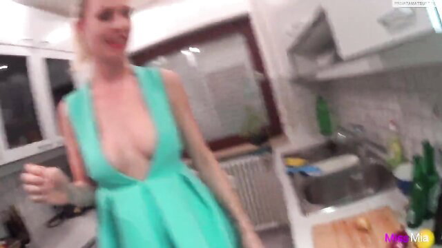 MissMia blonde in skimpy plunging green dress flashing cleavage in kitchen
