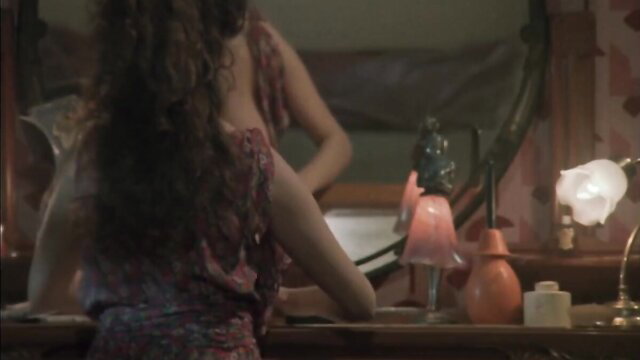 Debora Caprioglio in Paprika 1991, curvy brunette at vanity mirror