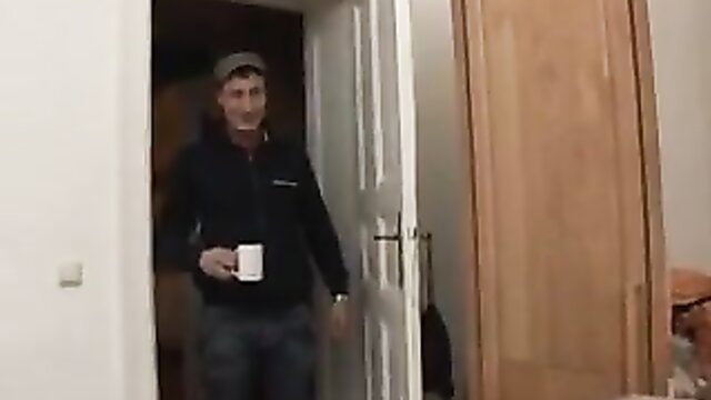 Skinny guy in hoodie holding mug at bedroom door in amateur fuck vid