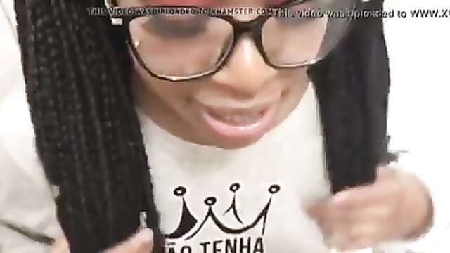 Closeup black woman with braids and glasses smirking in cumshot facial