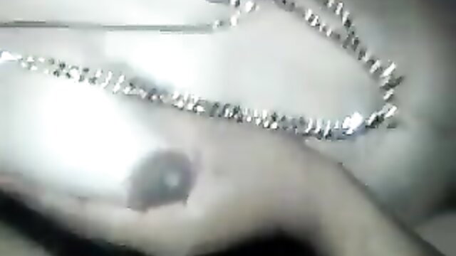 Indian babe's pierced nipple closeup with shiny jewelry necklace