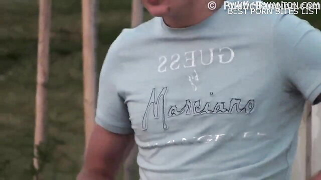 Hot guy in Guess Mariano t-shirt at outdoor public gangbang orgy
