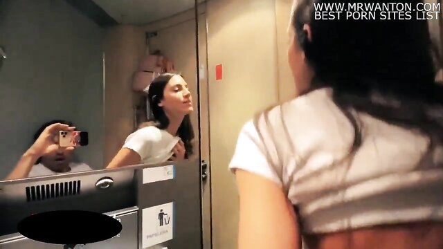 Asian babe in white crop top smiles at mirror selfie on train public amateur tease