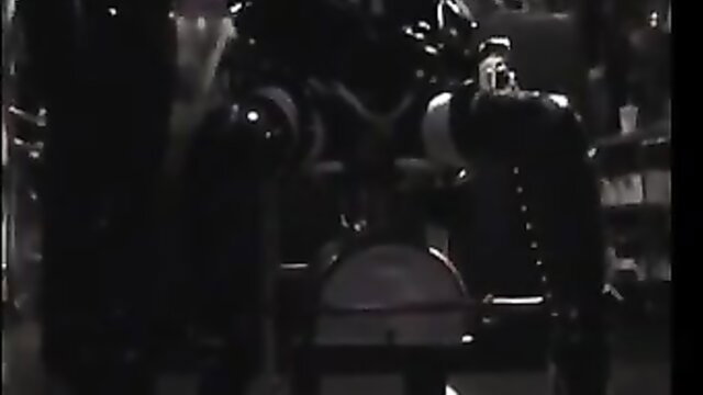 Rubber doll in latex mask fucked in dark dungeon by masked dom