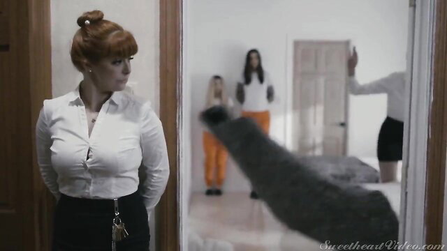 Penny Pax in prison guard uniform with inmate, action scene
