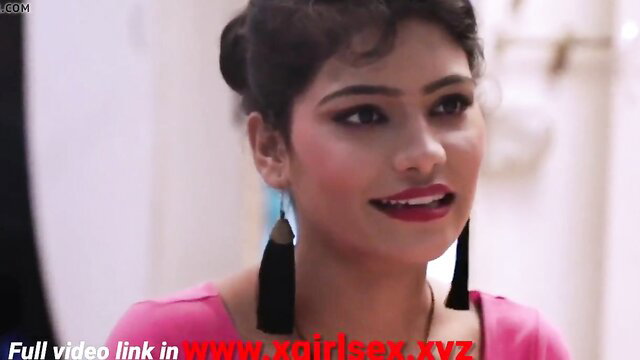 Indian housewife in pink top smiling seductively at camera