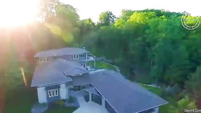 Super hot sexy callgirl posing at luxury modern house in forest at sunset