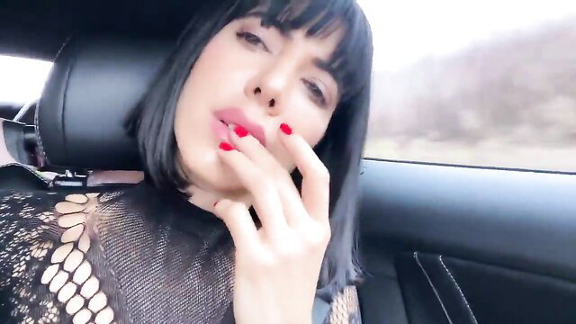 Milo Moire seductive car selfie, black bangs, red nails, lace top
