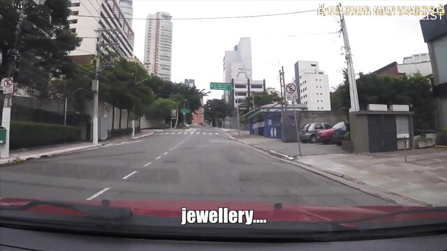 POV dashcam view driving past Brazilian jewelry store, gold digger spot