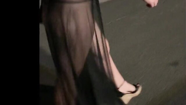 Sexy woman waddles ass in sheer black slit dress, legs exposed