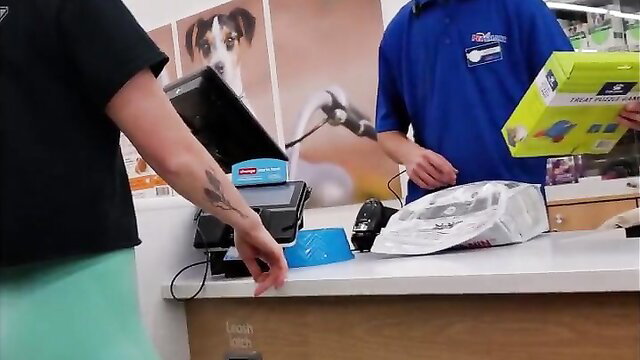 Blonde woman in tight green leggings at Petco counter, sexy wedgie ass
