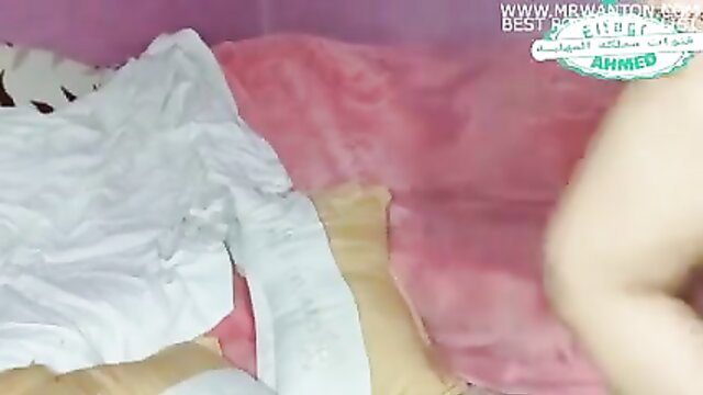 Arab woman Ghada Kalmani undressing on pink bed, hot amateur tease