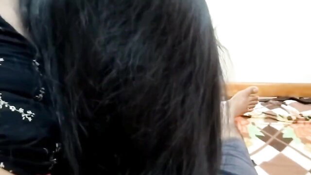 Busty Asian lady with long black hair shows bare foot and cleavage