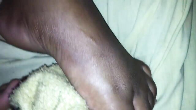 Ebony BBW foot closeup with towel on bed