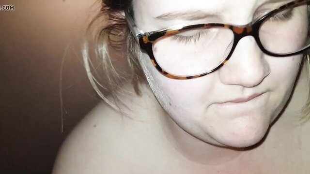 Blonde nerd girl with glasses pouts topless, tied tits slutty look