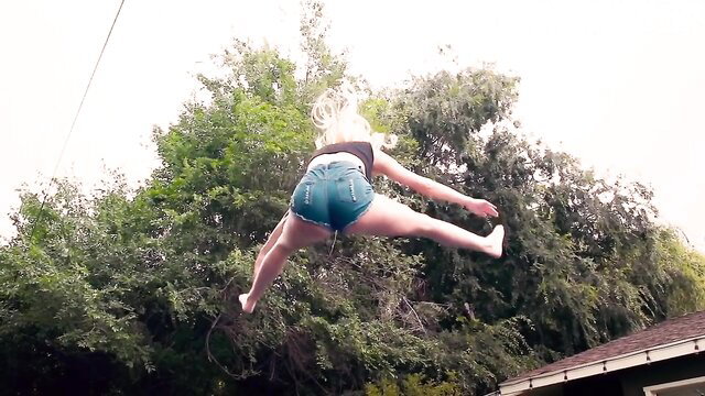 Blonde big ass babe in tiny denim shorts jumping outdoors