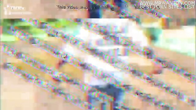 Blurry adult video thumbnail with green text overlays on www.mrwantan.com