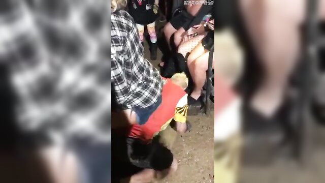 Clown worshiping girls' feet at crowded event, foot fetish frenzy