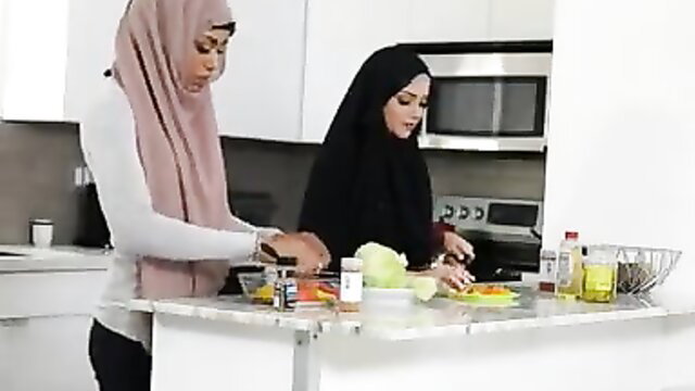 Milu Blaze in hijab chopping veggies in kitchen