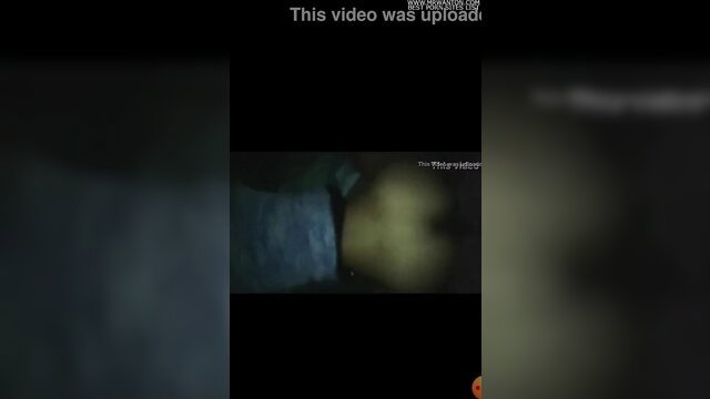Blurry adult video thumbnail of woman throwing ass back in dim light
