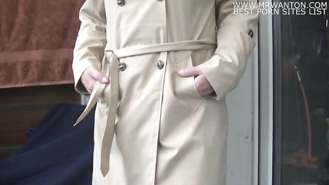 Blonde in beige trench coat flashing tits at door, fetish tease