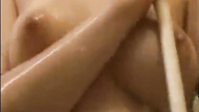 Closeup of wet Asian babe's big tits and arm in steamy tease