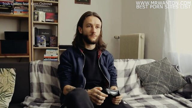 Long-haired guy in hoodie holds controller on couch in vampire neighbor porn