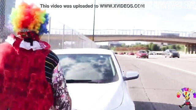 Gibby The Clown stands by car on Atlanta highway with Juicy Tee