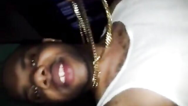 Black guy with gold chains lying back, smiling in amateur adult thumbnail