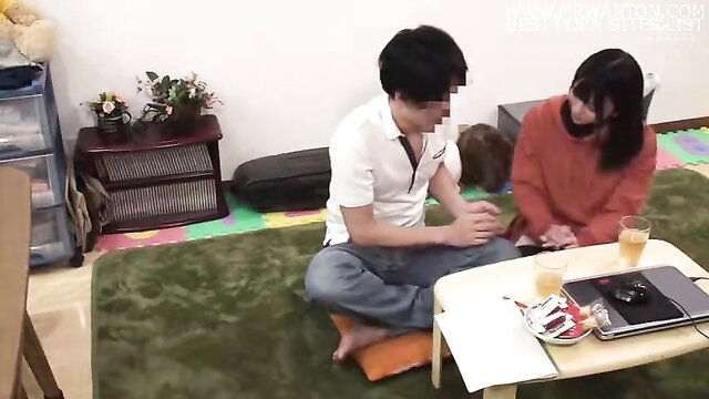 Japanese couple in cozy tatami room chat with drinks, casual home vibe