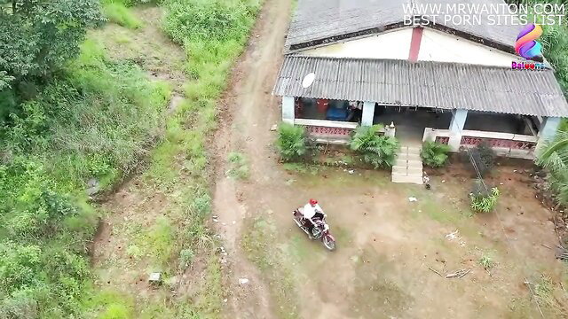 Drone view of Indian village house with biker outside