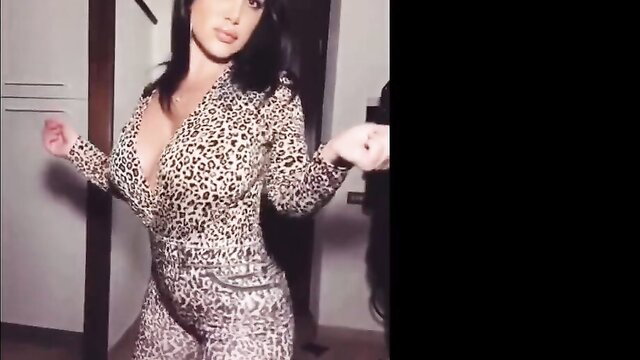 Latina bombshell in deep cleavage leopard print bodysuit dances seductively