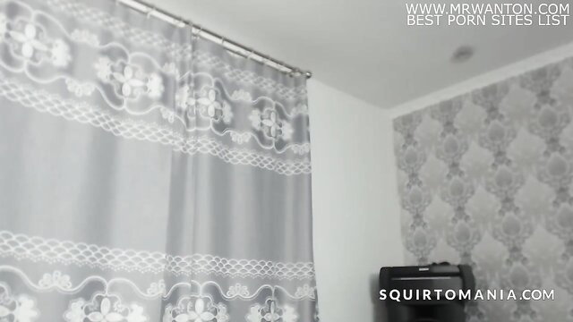 Shower curtain in empty bathroom, squirtmania watermark