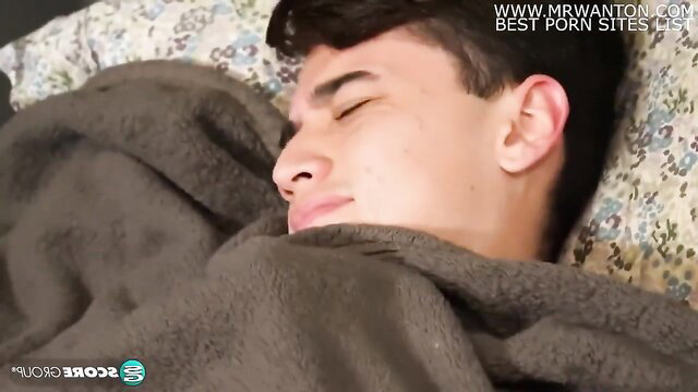 Young Latino twink sleeping nude under blanket in bed