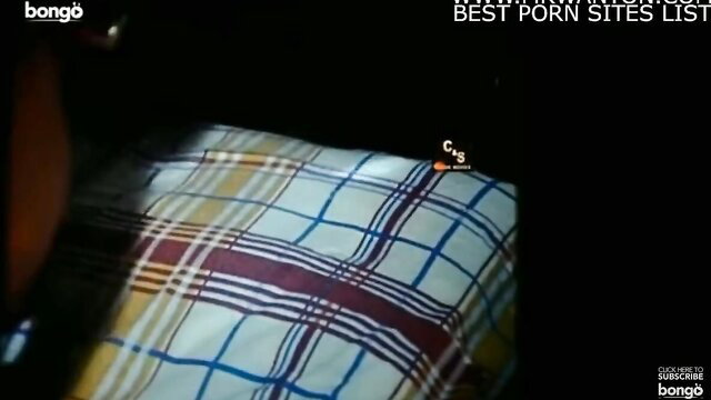 Closeup of woman on plaid blanket in Katawath Kiyannepa Sinhala film
