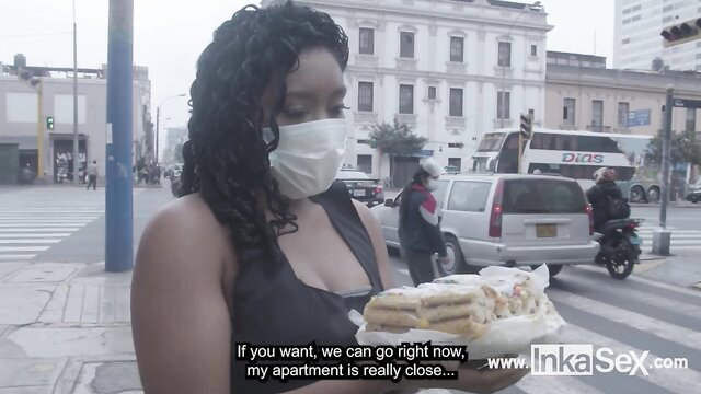 Peruvian brunette street vendor in mask offers nougat near her apt