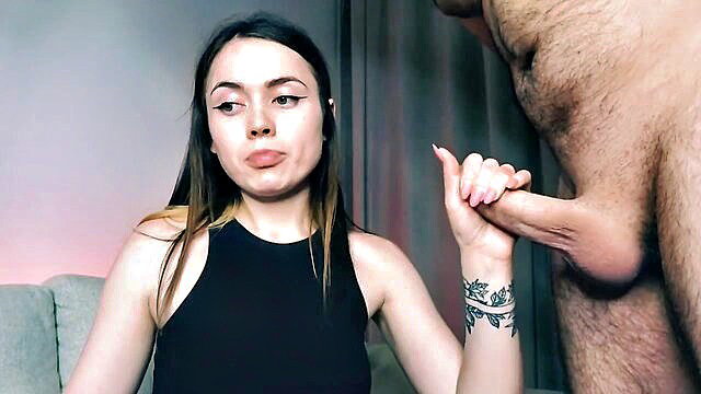 Beautiful brunette girl pouting while holding thick cock with hand