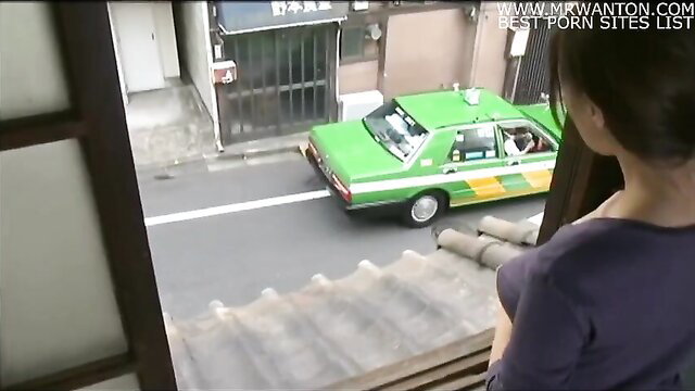 Japanese woman watching taxi from window in JAV VUK-582