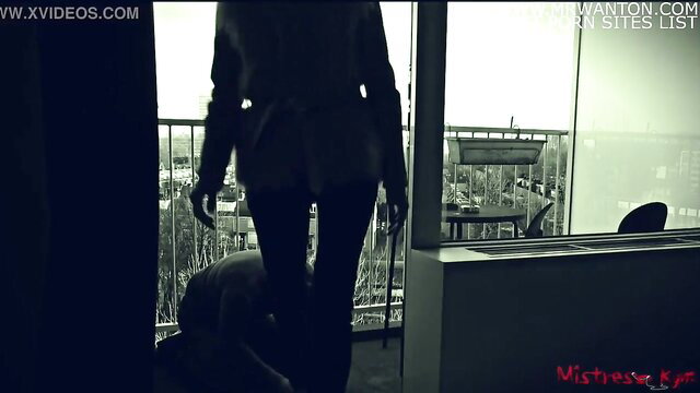 Mistress Kym's slave licks her high heels from behind, femdom tease