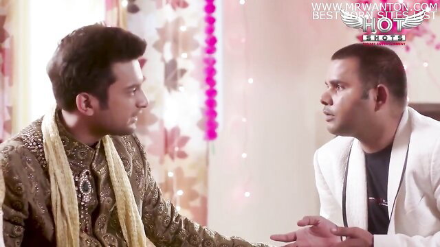 Two Indian men in traditional wedding attire talking intimately, hot gay scene