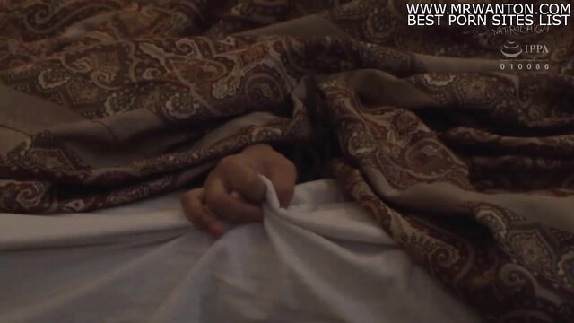 Asian woman with perfect tits under sheets enjoys sex