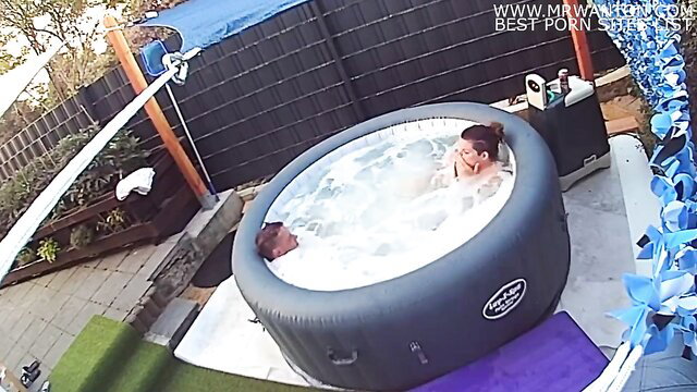 Hidden cam spies on busty brunette and guy fucking in hot tub