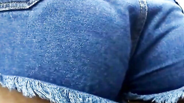 Mina's thick curvy ass in tight frayed blue denim shorts closeup